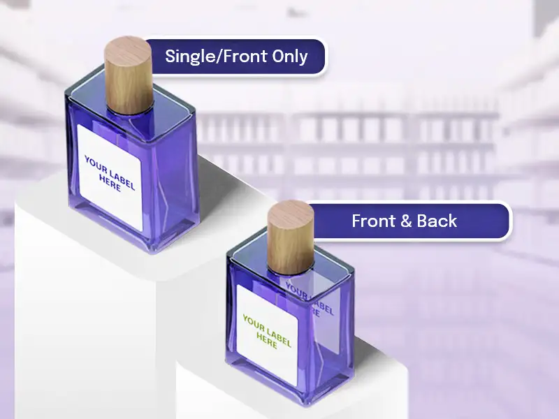 SIDE LABELLING - Cahaya Jakarta Packaging Two purple perfume bottles with wooden caps on a white pedestal, labels read'Your Label Here', with 'Single/Front Only' and 'Front & Back' tags visible.